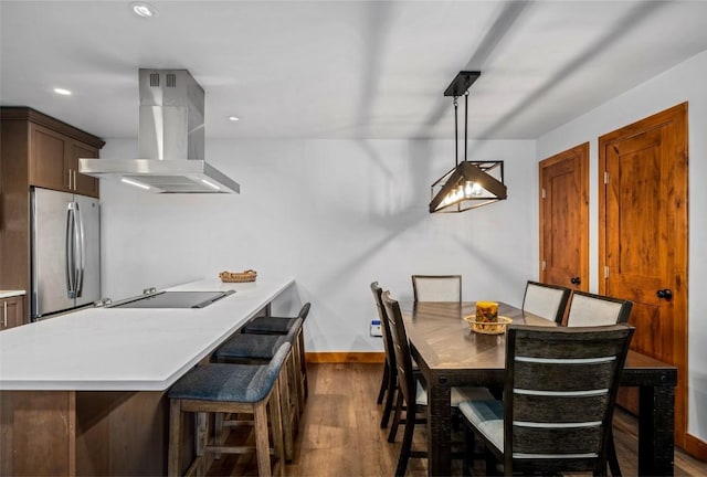 dining area with baseboards, recessed lighting, and dark wood-type flooring