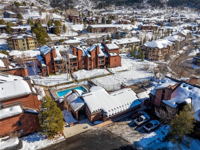 snowy aerial view with a residential view