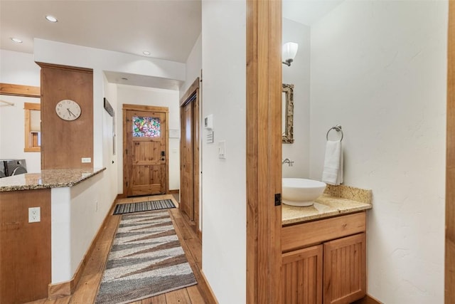 1110 Yampa St Unit R8, Steamboat Springs, CO 80487 - hallway featuring a sink, light wood-style floors, recessed lighting, and baseboards