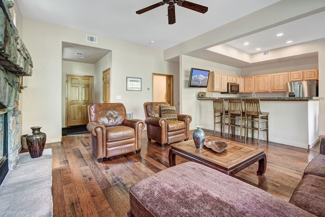 180 Robin Dr Unit 180, Silverthorne, CO 80498 - living area with wood-type flooring, a ceiling fan, recessed lighting, baseboards, and a fireplace