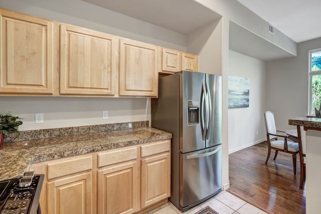 180 Robin Dr Unit 180, Silverthorne, CO 80498 - kitchen with stainless steel fridge, light brown cabinetry, tile counters, and light tile patterned flooring