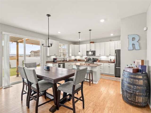 1527 Biffle Ct, Berthoud, CO 80513 - dining area featuring light wood-style flooring and recessed lighting