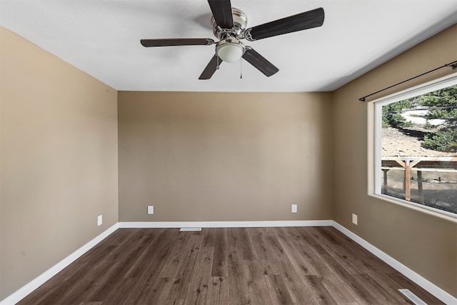 491 Valley Of The Sun Dr, Fairplay, CO 80440 - unfurnished room with dark wood-style floors, baseboards, and ceiling fan