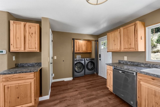 491 Valley Of The Sun Dr, Fairplay, CO 80440 - kitchen featuring stainless steel dishwasher, washer and clothes dryer, light brown cabinets, dark wood-style floors, and dark countertops