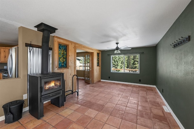 491 Valley Of The Sun Dr, Fairplay, CO 80440 - living room with a wood stove, a ceiling fan, and baseboards