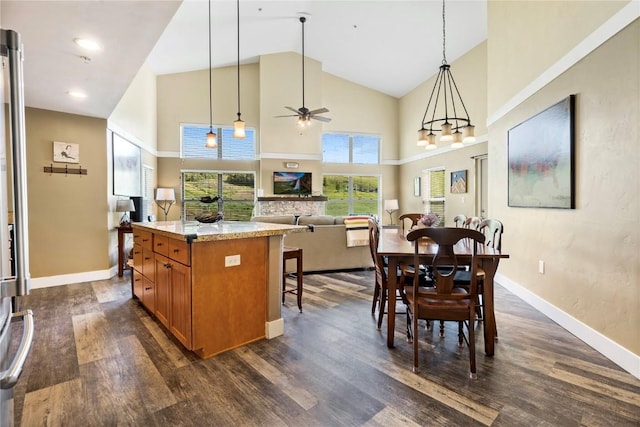 300 Base Camp Cir Unit 405, Granby, CO 80446 - kitchen featuring brown cabinets, a ceiling fan, dark wood-style floors, high vaulted ceiling, and pendant lighting