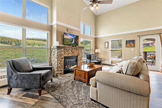 300 Base Camp Cir Unit 405, Granby, CO 80446 - living room with high vaulted ceiling, a ceiling fan, a fireplace, wood finished floors, and radiator