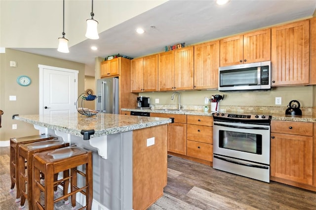 300 Base Camp Cir Unit 405, Granby, CO 80446 - kitchen with appliances with stainless steel finishes, dark wood-type flooring, a center island, recessed lighting, and a breakfast bar area