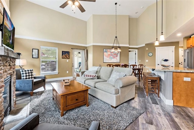 300 Base Camp Cir Unit 405, Granby, CO 80446 - living room featuring high vaulted ceiling, a fireplace, ceiling fan, dark wood-style floors, and a chandelier