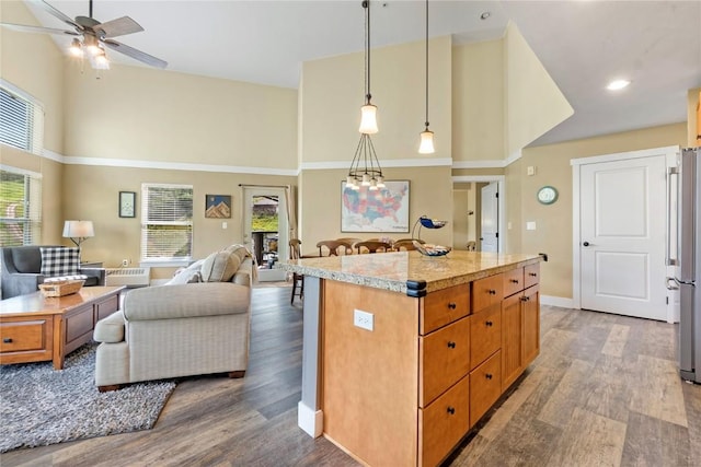 300 Base Camp Cir Unit 405, Granby, CO 80446 - kitchen with a towering ceiling, open floor plan, wood finished floors, ceiling fan, and freestanding refrigerator