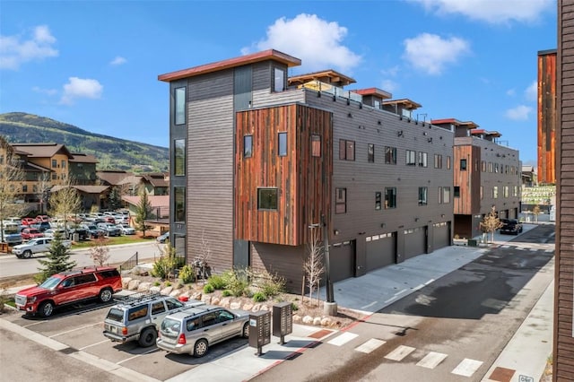 2894 Owl Hoot Trl, Steamboat Springs, CO 80487 - view of building exterior featuring an attached garage and a mountain view