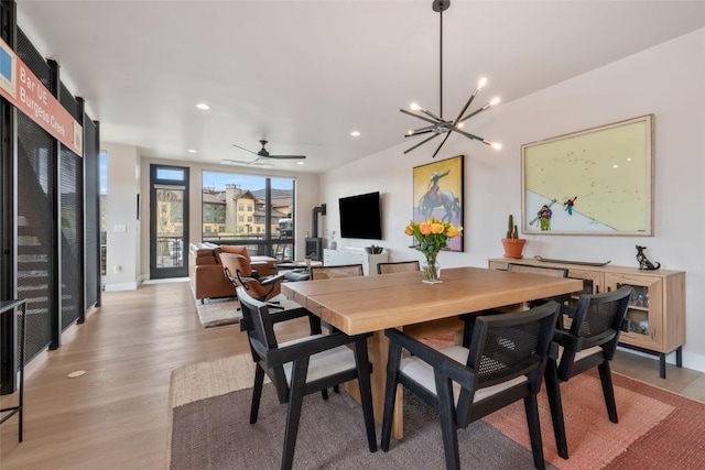 2894 Owl Hoot Trl, Steamboat Springs, CO 80487 - dining room featuring light wood finished floors, a chandelier, recessed lighting, a ceiling fan, and baseboards