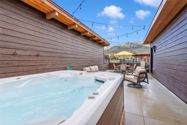 2894 Owl Hoot Trl, Steamboat Springs, CO 80487 - view of patio / terrace featuring outdoor dining space, a hot tub, and a mountain view