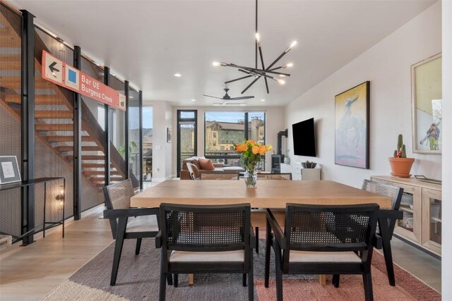 2894 Owl Hoot Trl, Steamboat Springs, CO 80487 - dining room with a chandelier, stairway, light wood finished floors, recessed lighting, and ceiling fan