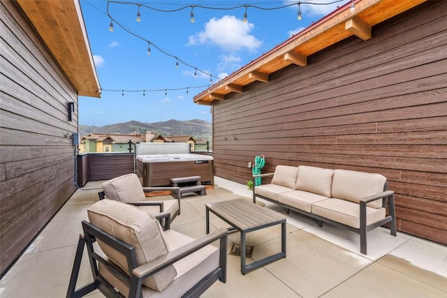 2894 Owl Hoot Trl, Steamboat Springs, CO 80487 - view of patio / terrace with a hot tub, an outdoor hangout area, and a mountain view