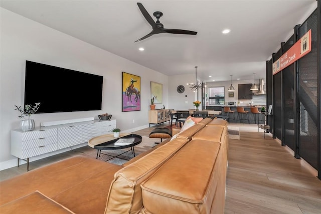 2894 Owl Hoot Trl, Steamboat Springs, CO 80487 - living room featuring ceiling fan, light wood-type flooring, a chandelier, recessed lighting, and baseboards