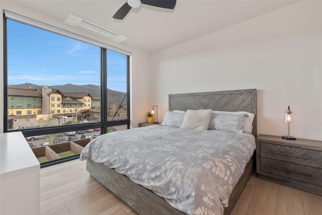 2894 Owl Hoot Trl, Steamboat Springs, CO 80487 - bedroom with wood finished floors, a mountain view, a ceiling fan, and lofted ceiling