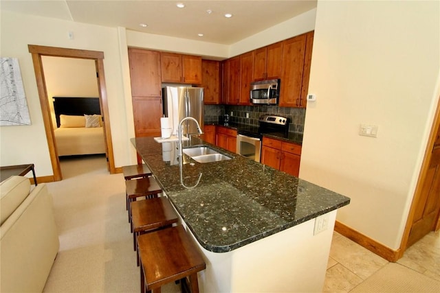 30 Union Creek Trl Bldg 2 # 201, Copper Mountain, CO 80443 - kitchen with stainless steel appliances, a kitchen breakfast bar, a sink, tasteful backsplash, and baseboards