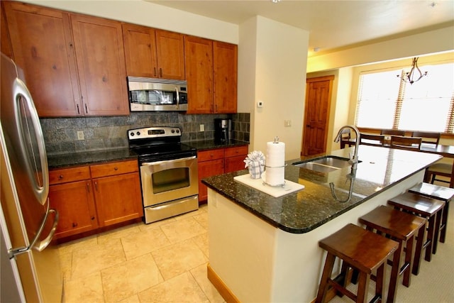 30 Union Creek Trl Bldg 2 # 201, Copper Mountain, CO 80443 - kitchen with brown cabinetry, tasteful backsplash, stainless steel appliances, and a sink