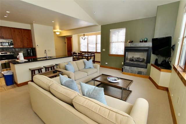 30 Union Creek Trl Bldg 2 # 201, Copper Mountain, CO 80443 - living area with vaulted ceiling, light carpet, an inviting chandelier, a tiled fireplace, and recessed lighting