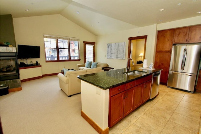 30 Union Creek Trl Bldg 2 # 201, Copper Mountain, CO 80443 - kitchen with dark stone countertops, vaulted ceiling, a sink, a center island with sink, and appliances with stainless steel finishes