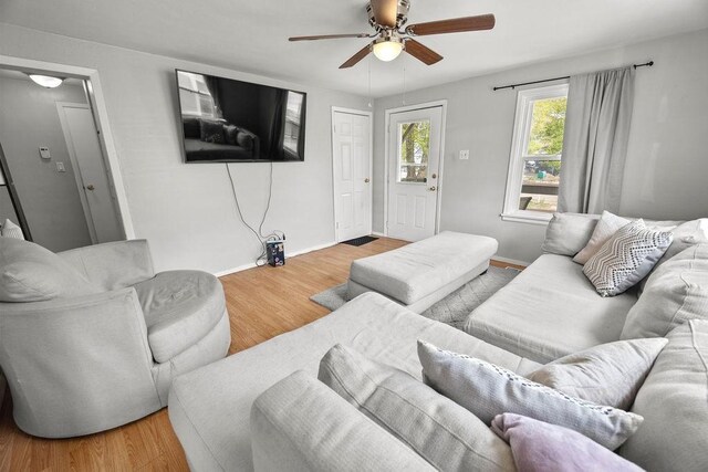 410 Washington St, Craig, CO 81625 - living area featuring a ceiling fan, wood finished floors, and baseboards