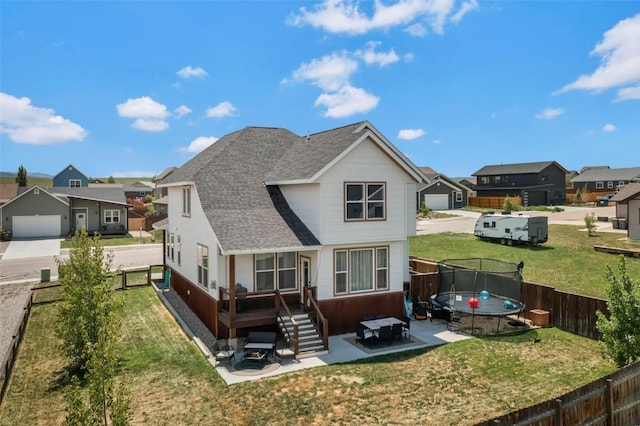 342 Lake View Rd, Hayden, CO 81639 - back of house featuring a trampoline, a residential view, a shingled roof, and a patio area