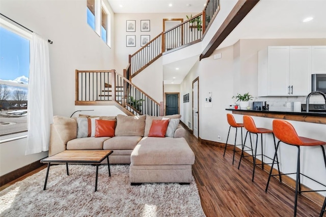 342 Lake View Rd, Hayden, CO 81639 - living room with recessed lighting, baseboards, dark wood-type flooring, a towering ceiling, and stairway