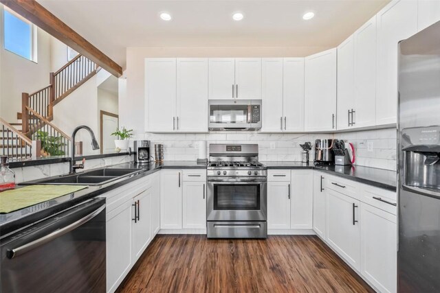 342 Lake View Rd, Hayden, CO 81639 - kitchen featuring a sink, dark countertops, stainless steel appliances, and dark wood finished floors