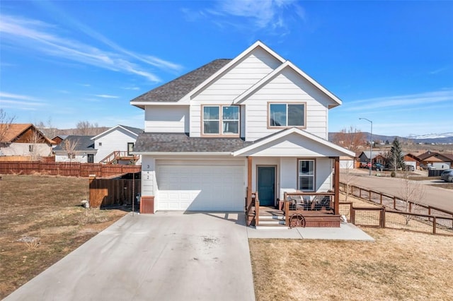 342 Lake View Rd, Hayden, CO 81639 - traditional-style house featuring a porch, a garage, fence, concrete driveway, and a shingled roof