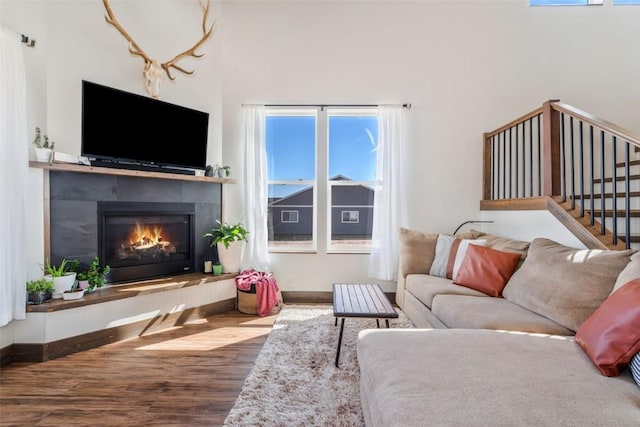 342 Lake View Rd, Hayden, CO 81639 - living room featuring stairs, wood finished floors, and a tile fireplace
