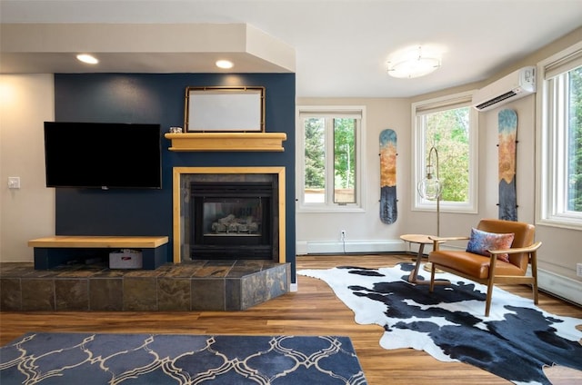 2800 Eagleridge Dr Unit C1, Steamboat Springs, CO 80487 - living area with an AC wall unit, wood finished floors, a tiled fireplace, and recessed lighting