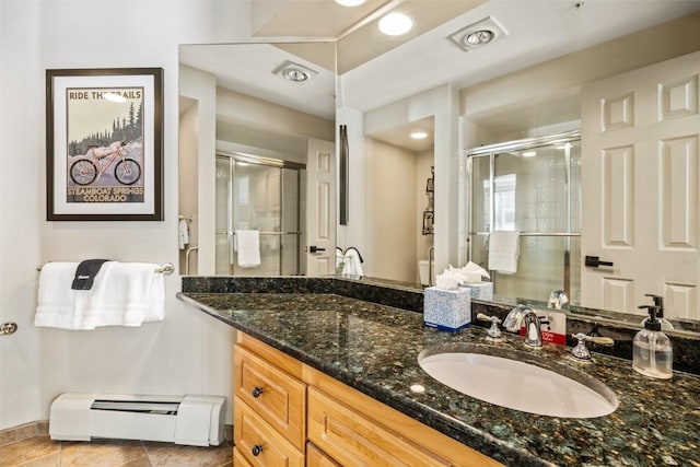 2800 Eagleridge Dr Unit C1, Steamboat Springs, CO 80487 - full bathroom with a baseboard heating unit, a stall shower, vanity, and tile patterned floors
