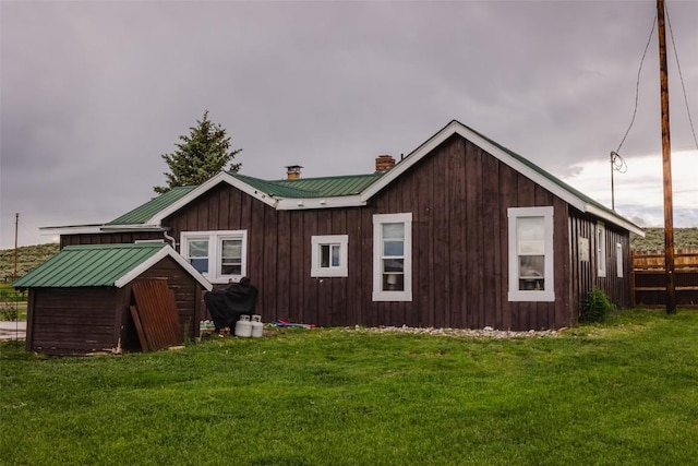 33685 State Highway 134, Toponas, CO 80479 - rear view of house with a chimney, a metal roof, a yard, and a standing seam roof