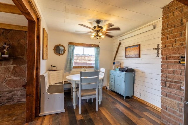 33685 State Highway 134, Toponas, CO 80479 - dining room featuring dark wood-type flooring, a ceiling fan, and wooden walls