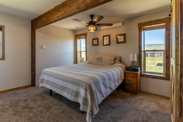33685 State Highway 134, Toponas, CO 80479 - bedroom featuring multiple windows, carpet, beam ceiling, and a ceiling fan