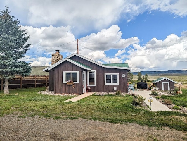 33685 State Highway 134, Toponas, CO 80479 - rear view of house featuring a chimney and an outdoor structure