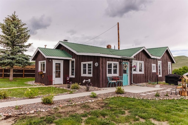 33685 State Highway 134, Toponas, CO 80479 - view of front of house with board and batten siding, a chimney, and a metal roof