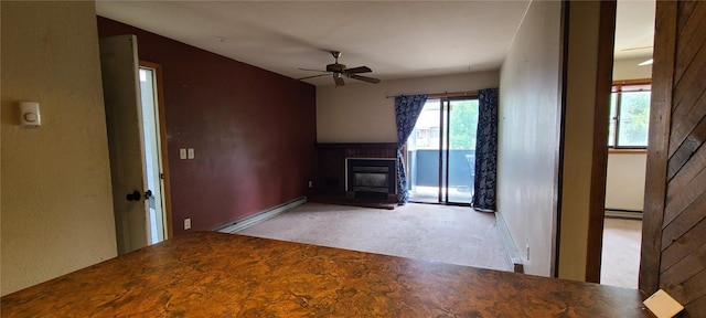 1335 Sparta Plz Unit 7, Steamboat Springs, CO 80487 - unfurnished living room featuring a glass covered fireplace, carpet flooring, a ceiling fan, and a baseboard radiator
