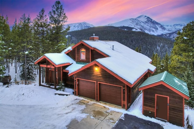 181 Red Fox Ct, Breckenridge, CO 80424 - chalet / cabin featuring a chimney, a mountain view, and a garage