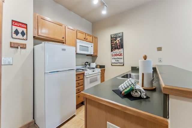 91 River Run Rd Unit 8117, Keystone, CO 80435 - kitchen with light brown cabinetry, dark countertops, white appliances, rail lighting, and light tile patterned floors