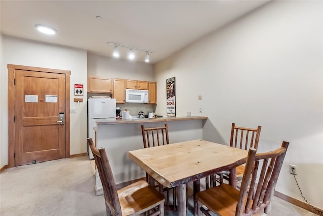 91 River Run Rd Unit 8117, Keystone, CO 80435 - dining space featuring track lighting, baseboards, and light carpet