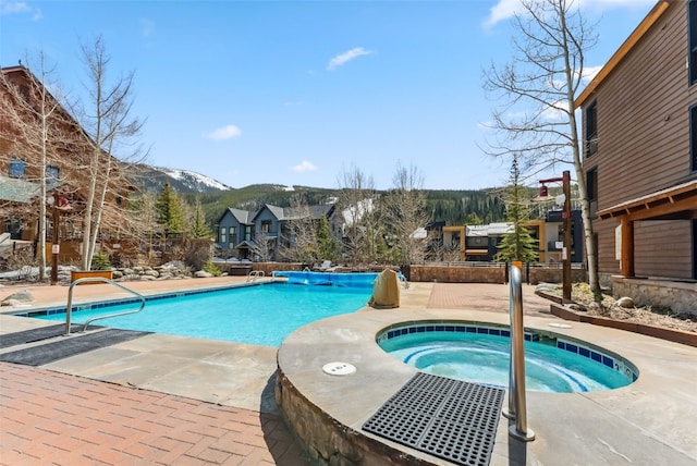 91 River Run Rd Unit 8117, Keystone, CO 80435 - community pool with a mountain view, a hot tub, and a patio area