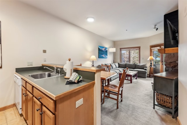 91 River Run Rd Unit 8117, Keystone, CO 80435 - kitchen featuring a sink, brown cabinetry, open floor plan, dishwasher, and a peninsula