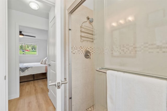 1565 Shadow Run Frontage Unit 103, Steamboat Springs, CO 80487 - bathroom with wood finished floors, a stall shower, ensuite bath, and a ceiling fan