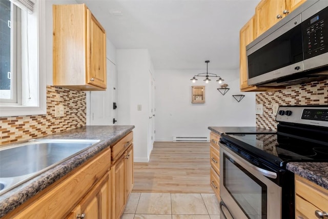 1565 Shadow Run Frontage Unit 103, Steamboat Springs, CO 80487 - kitchen with appliances with stainless steel finishes, dark countertops, decorative backsplash, and a sink
