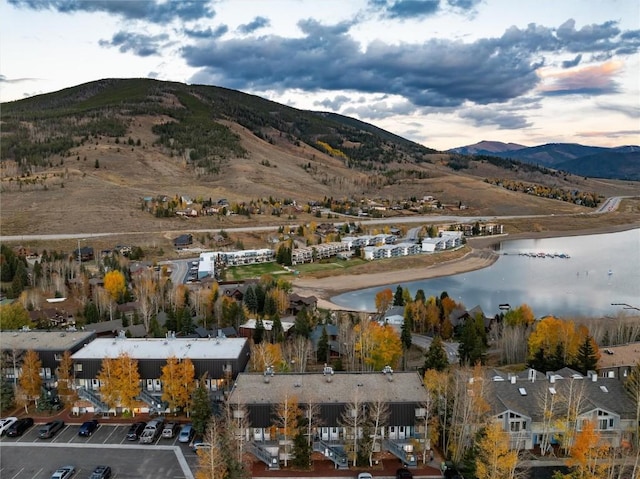 drone / aerial view featuring a water and mountain view