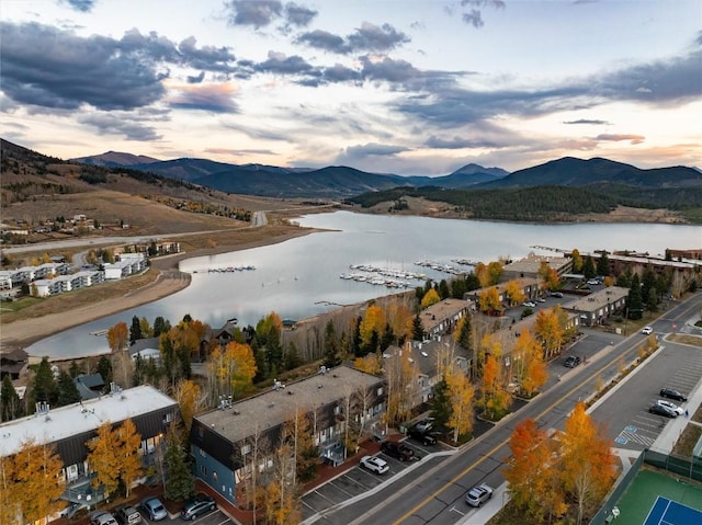 drone / aerial view featuring a water and mountain view