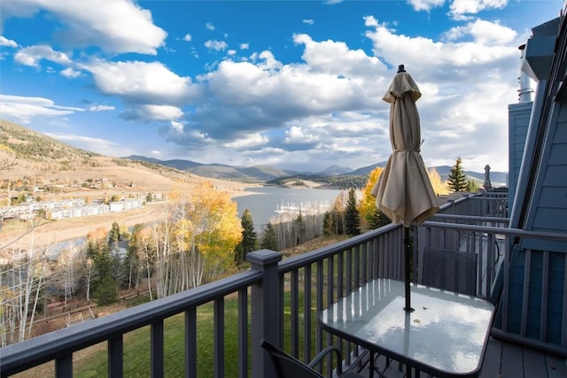 wooden deck featuring a water and mountain view