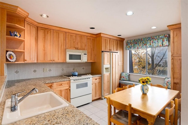 kitchen featuring a sink, decorative backsplash, white appliances, open shelves, and light countertops